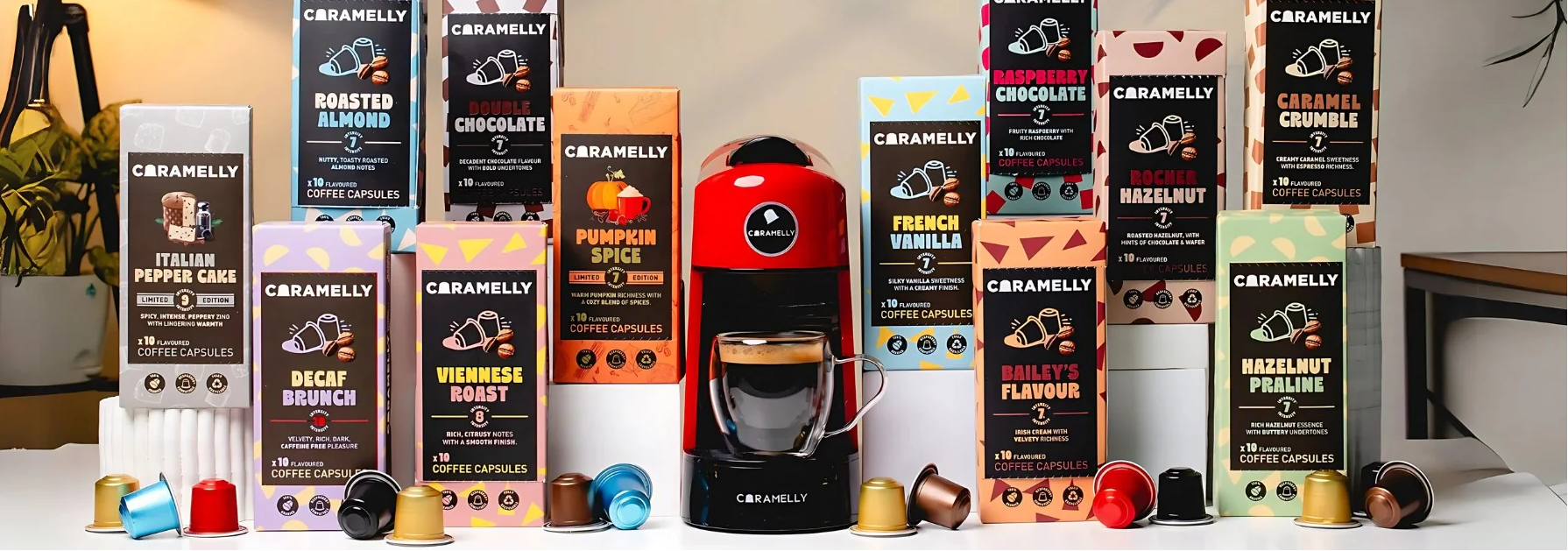 Assorted coffee pod packages with a coffee machine on a light background