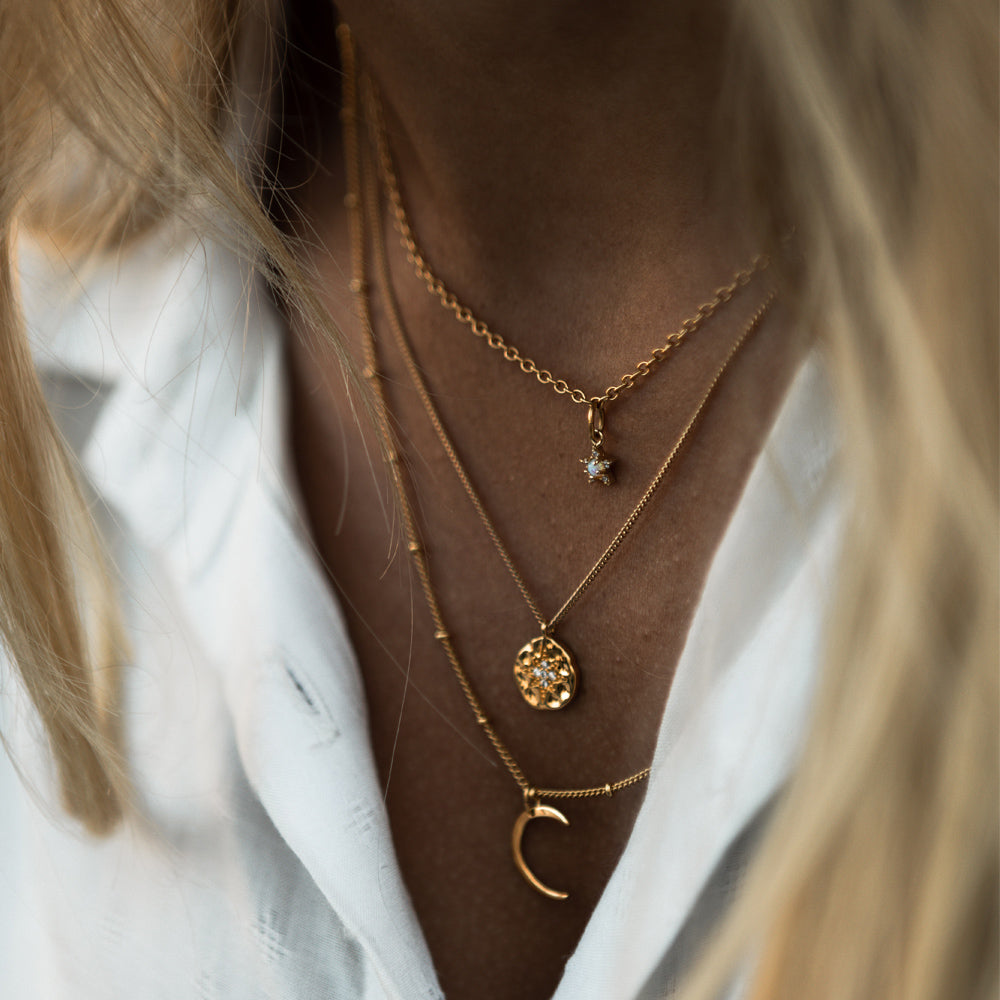 dainty jewelery layered necklaces on woman 